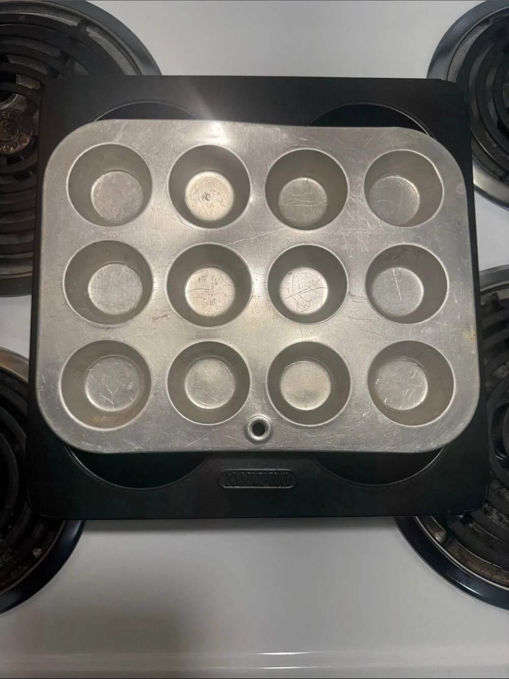 Two muffin pans, the large one is non-stick and NWOT. Small one is in GUC.